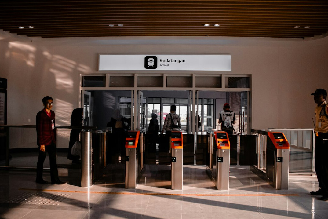 Business visitors using a self check-in kiosk in a lobby